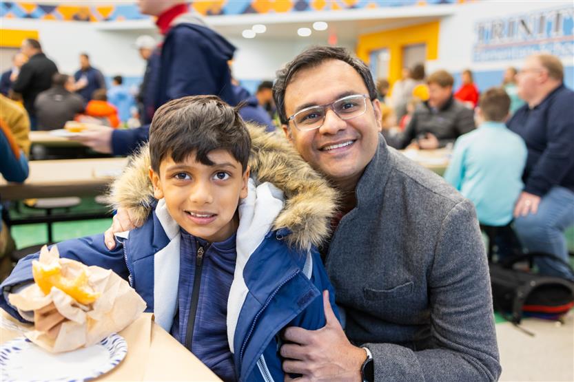 Trinity Elementary students eat donuts with dudes